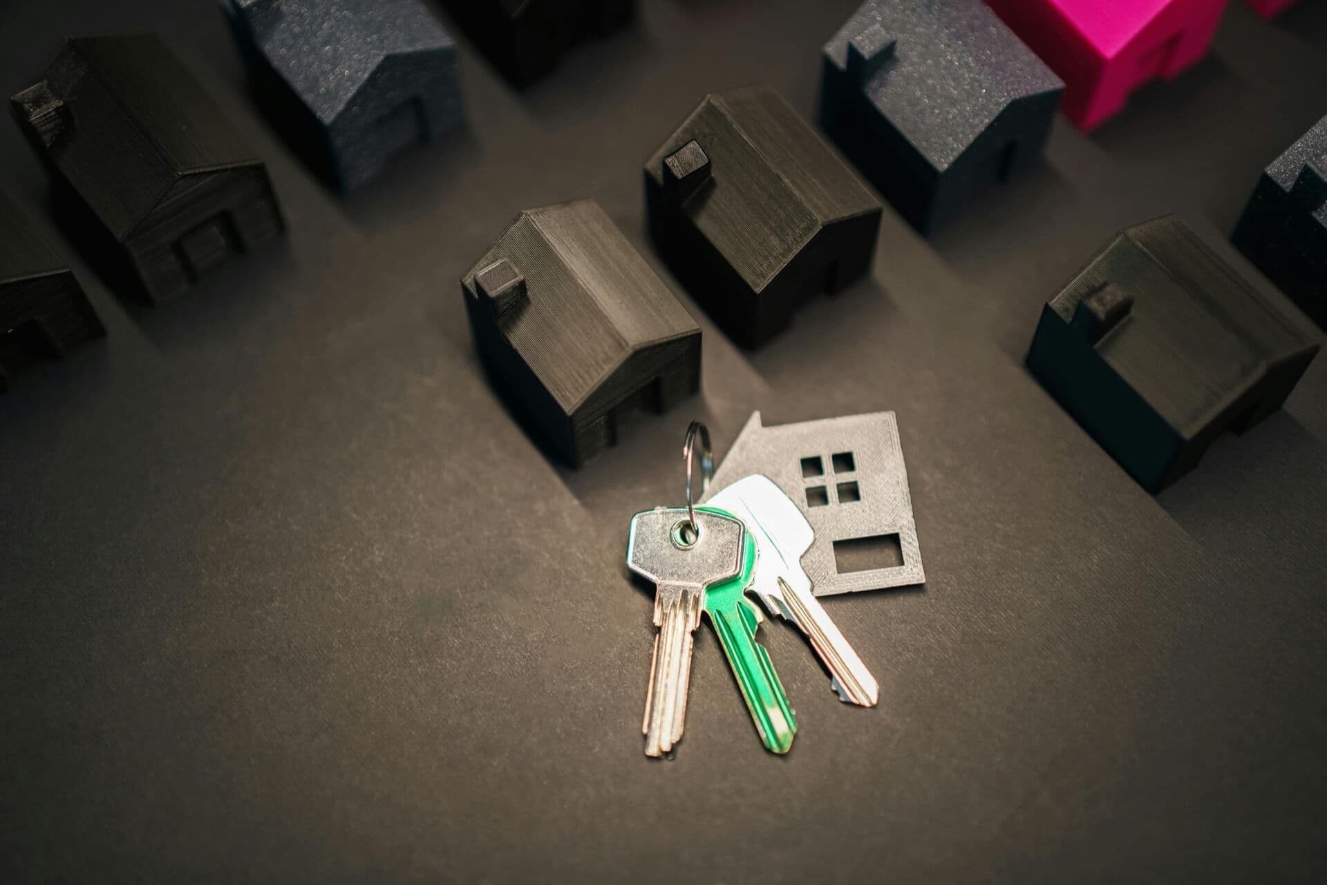 Locksmith keys with house models representing secure real estate in Oklahoma City