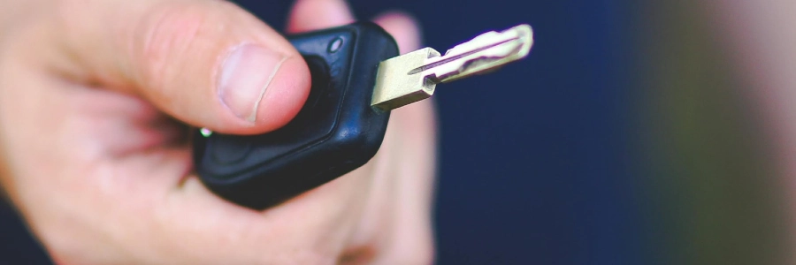 A person holding a car key fob after locksmith service in oklahoma city
