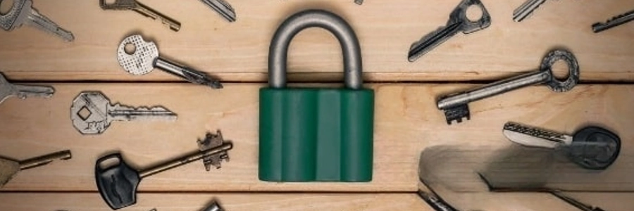 Padlock surrounded by old keys on wooden background