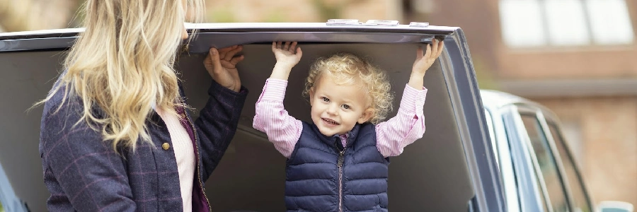 a mother and a child sitting in the back of a car